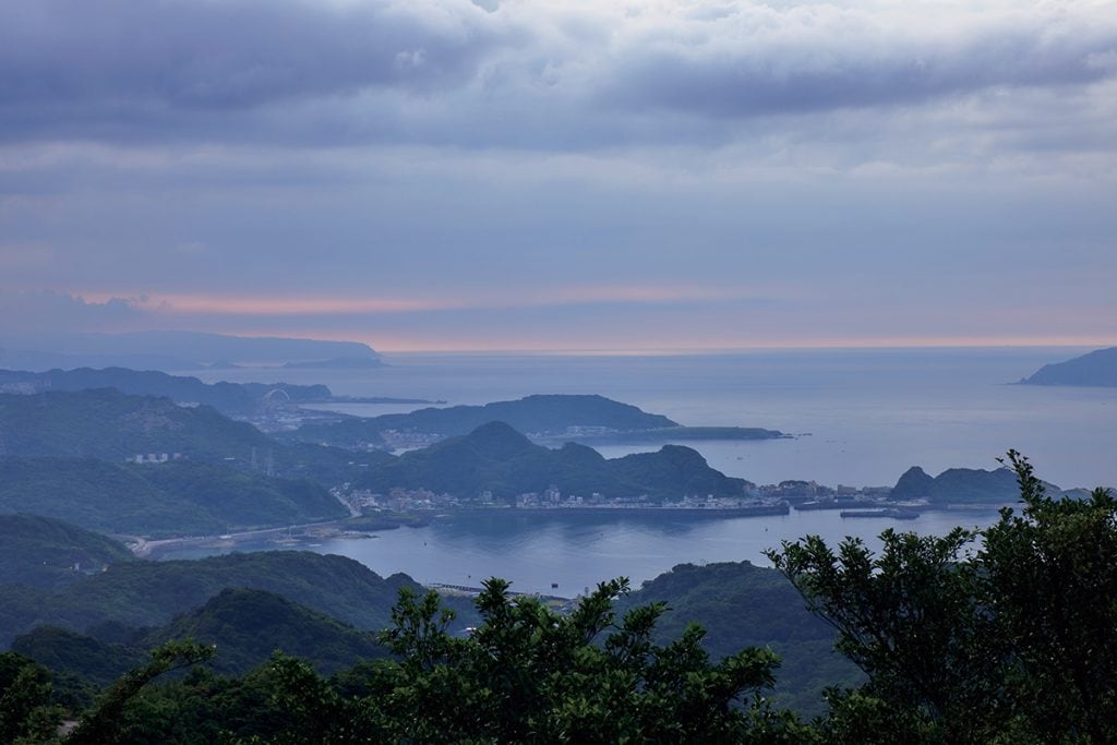 高台から望む陰陽海。霞の向こうに見える夕焼け空や山の峰々が幻想的。