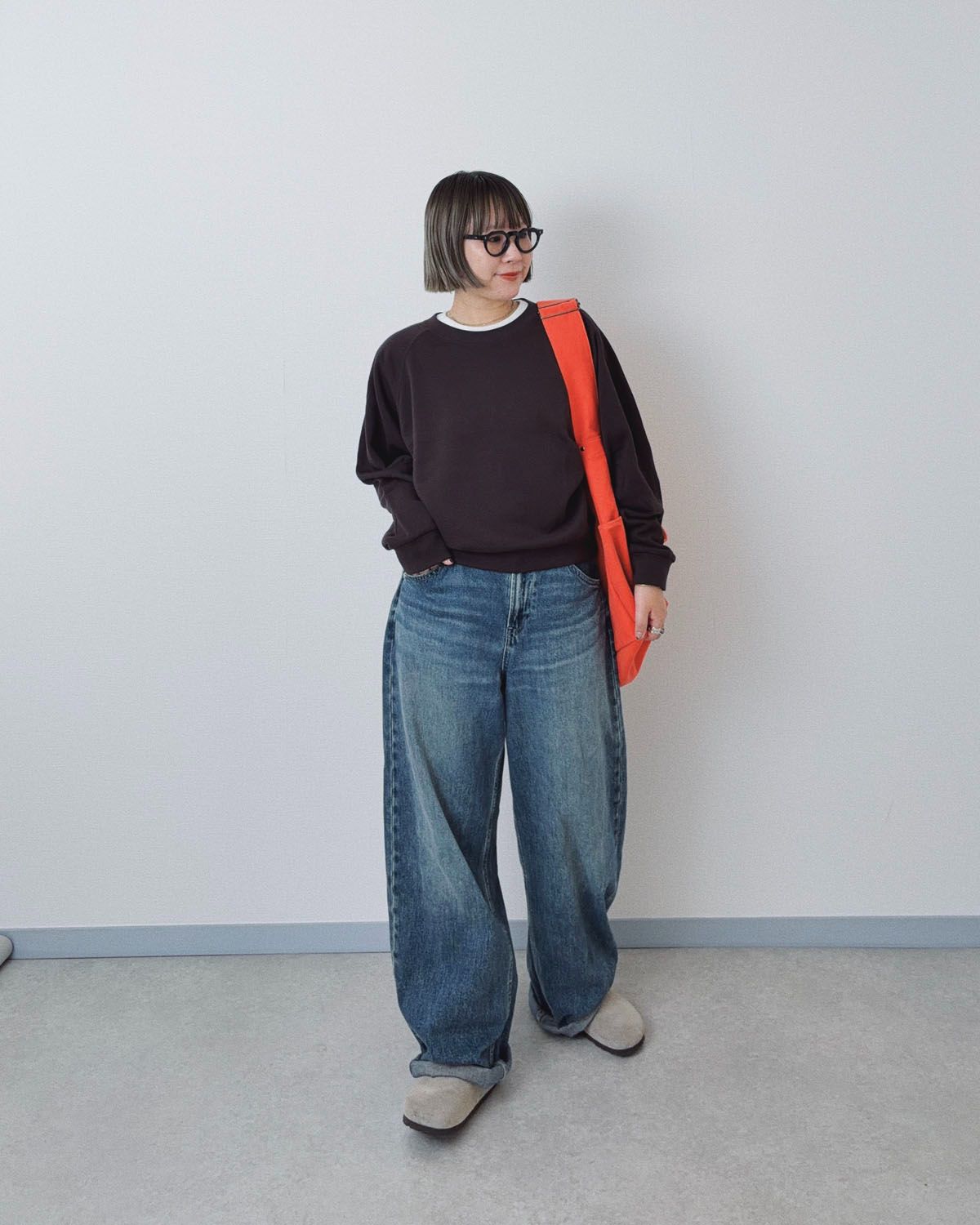 ユニクロのバギージーンズとシンプルなスウェットに、差し色でビタミンカラーのバッグを