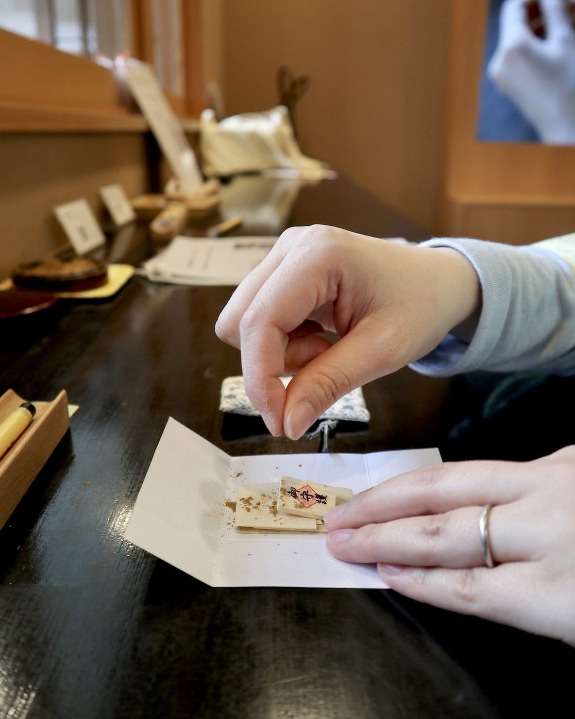 京都・両足院のお守り(結守)に塗香を入れているところ