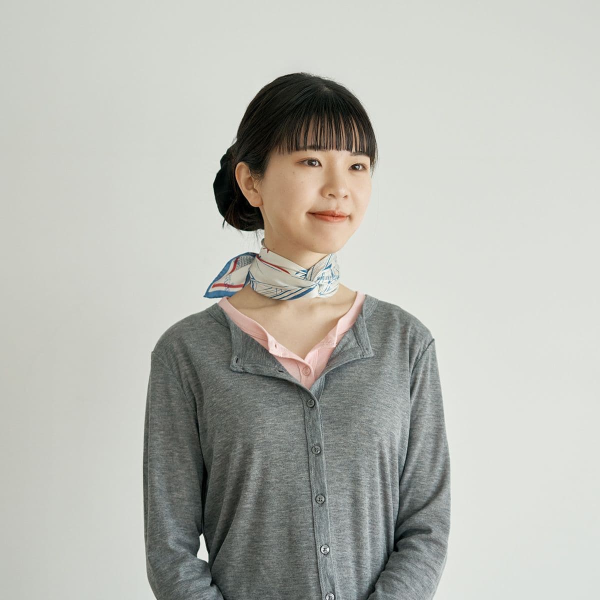 コンパクトな巻き方で、首もとをすっきり見せるバックシンプルツイスト巻き