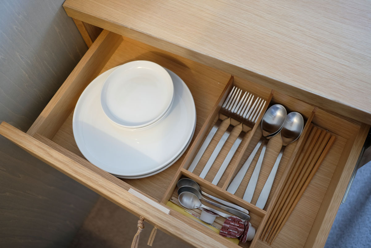 MUJI BASE KYOTO kiyomizu。ファミリールームにあるキッチのン引き出しを開けると、無印良品のシンプルで使いやすい食器類が美しく並びます。